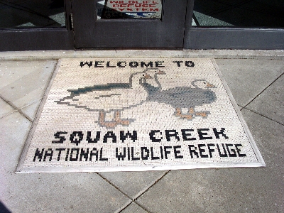 [Mosaic mat with refuge's name and bird symbols on it.]